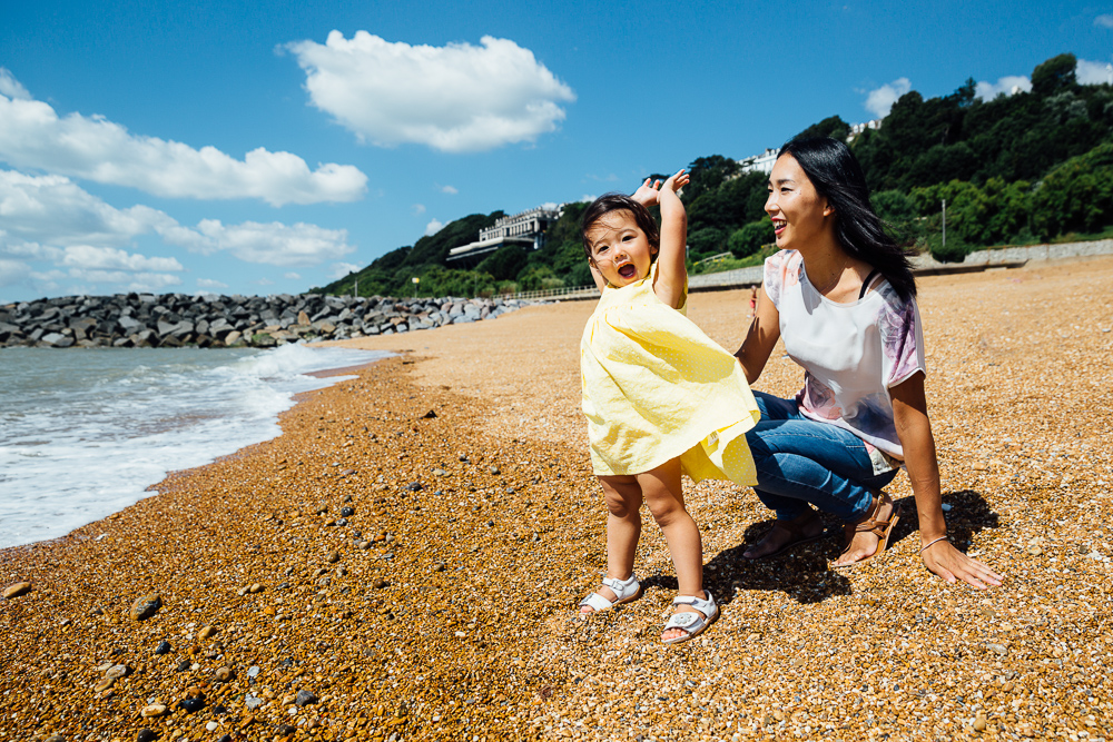 family photography of toddler girl and mother playing at the beach, folkestone, kent
