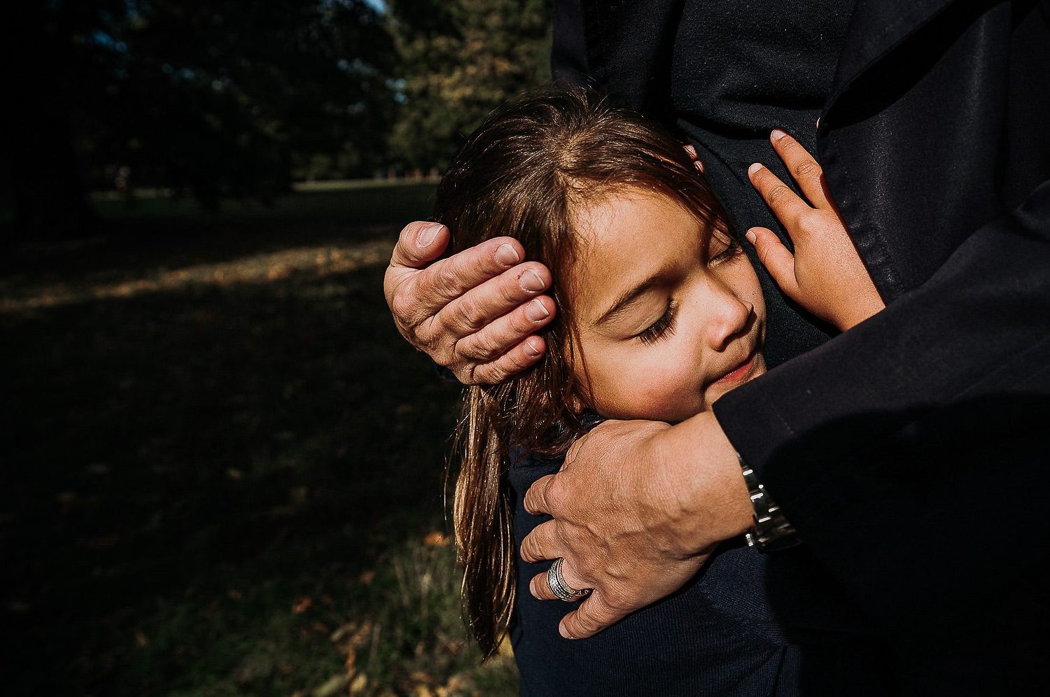 london family photographer parent embracing child's face close up shot